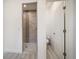 Modern shower with light wood look tile and a dark decorative accent stripe at 5547 Silver Sun Dr, Apollo Beach, FL 33572