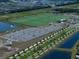 Aerial view of the community sports field, parking lot, and playground, designed for recreation and leisure at 5547 Silver Sun Dr, Apollo Beach, FL 33572
