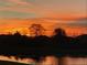 Picturesque sunset over a tranquil lake, creating a peaceful and scenic view at 5547 Silver Sun Dr, Apollo Beach, FL 33572
