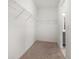 Spacious walk-in closet with carpet and metal shelving at 5547 Silver Sun Dr, Apollo Beach, FL 33572