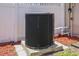 Exterior air conditioning unit sitting on a concrete pad with white fencing in background and yard clippings at 5761 Colonial Dr, New Port Richey, FL 34653