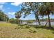 Relax in the shade of mature trees while enjoying the serene waterfront views from the backyard at 5761 Colonial Dr, New Port Richey, FL 34653