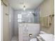 Modern bathroom featuring a walk-in shower with glass enclosure, decorative tile, and sleek fixtures at 5761 Colonial Dr, New Port Richey, FL 34653