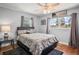 Bright bedroom with a ceiling fan, windows, and hardwood floors at 5761 Colonial Dr, New Port Richey, FL 34653
