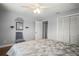 Bright bedroom featuring a ceiling fan, closet, hardwood floors and neutral paint at 5761 Colonial Dr, New Port Richey, FL 34653