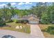 A charming single-story home with lush landscaping, solar panels and a brick driveway, offers tranquil water views at 5761 Colonial Dr, New Port Richey, FL 34653