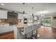 Modern kitchen featuring an island with marble countertop, stainless steel appliances, and wood flooring at 5761 Colonial Dr, New Port Richey, FL 34653