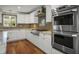 Stylish kitchen with stainless steel double oven, white cabinets, and a contrasting backsplash at 5761 Colonial Dr, New Port Richey, FL 34653