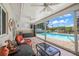Enclosed lanai with wood-look tile flooring, ceiling fans, and a view of the pool at 5761 Colonial Dr, New Port Richey, FL 34653