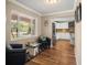 Cozy sitting area adjacent to a modern kitchen with hardwood floors and ample natural light at 5761 Colonial Dr, New Port Richey, FL 34653