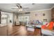 Inviting living room with hardwood floors, neutral decor, and comfortable seating near a large window at 5761 Colonial Dr, New Port Richey, FL 34653