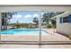 View of the private pool and patio area from the enclosed lanai at 5761 Colonial Dr, New Port Richey, FL 34653
