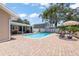Relax by the in-ground pool on a brick patio, perfect for enjoying the outdoors at 5761 Colonial Dr, New Port Richey, FL 34653