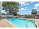 Backyard pool with brick patio, and seating area overlooking the water at 5761 Colonial Dr, New Port Richey, FL 34653