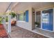 Charming front porch featuring brick flooring, comfortable seating, and hanging flower baskets at 5761 Colonial Dr, New Port Richey, FL 34653