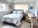 Cozy bedroom featuring a queen bed with coastal-themed bedding, a ceiling fan, and bright natural light at 6880 Versailles N, Pinellas Park, FL 33781