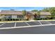 Exterior shot of the community clubhouse with well-maintained landscaping and ample parking at 6880 Versailles N, Pinellas Park, FL 33781