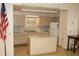 Community kitchen area with island, ample counter space, and cabinets at 6880 Versailles N, Pinellas Park, FL 33781
