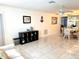 Spacious living room open to the dining area with tile floors and plenty of natural light at 6880 Versailles N, Pinellas Park, FL 33781
