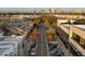 Aerial view of a community with shopping, tree-lined streets, and a cityscape in the distance at 800 S Dakota Ave # 241, Tampa, FL 33606