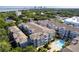 Scenic aerial view of community featuring a pool, lush landscaping, and a glimpse of the city skyline at 800 S Dakota Ave # 241, Tampa, FL 33606