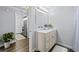 Clean bathroom featuring a marble countertop vanity with ample storage, and a view into laundry area at 800 S Dakota Ave # 241, Tampa, FL 33606