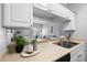 Kitchen sink and countertop area with view into living room, showcasing open layout and natural light at 800 S Dakota Ave # 241, Tampa, FL 33606