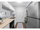 Clean kitchen with stainless steel appliances, white cabinets, and a view into the adjacent living area at 800 S Dakota Ave # 241, Tampa, FL 33606