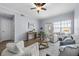 Cozy living room featuring a ceiling fan, hardwood floors, modern furniture, and a bright window at 800 S Dakota Ave # 241, Tampa, FL 33606