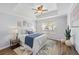 Bright primary bedroom with tray ceiling, ceiling fan, large window, and neutral decor at 800 S Dakota Ave # 241, Tampa, FL 33606