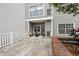 A charming outdoor patio featuring cozy seating and a quaint brick garden bed at 800 S Dakota Ave # 241, Tampa, FL 33606