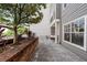 Back patio with brick planters, paver flooring, and views of the surrounding building at 800 S Dakota Ave # 241, Tampa, FL 33606