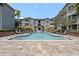 Inviting community pool surrounded by lounge chairs and lush landscaping at 800 S Dakota Ave # 241, Tampa, FL 33606