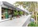 Street view of shops with greenery, bench, and sidewalks at 800 S Dakota Ave # 241, Tampa, FL 33606