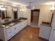 Bathroom features a vanity with granite countertops, double sinks, and modern lighting at 8025 Island Dr, Port Richey, FL 34668