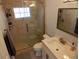 Well-lit bathroom featuring a glass shower, vanity with sink, and modern fixtures at 8025 Island Dr, Port Richey, FL 34668