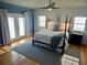Stylish bedroom with hardwood floors, shiplap accent wall, and a large bed with blue accents at 8025 Island Dr, Port Richey, FL 34668