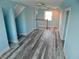 Spacious bonus room with wood-look flooring, bright light, and a cozy design at 8025 Island Dr, Port Richey, FL 34668