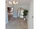 Inviting foyer with tile flooring, a decorative mirror, and views into other living spaces at 8025 Island Dr, Port Richey, FL 34668
