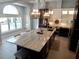Modern kitchen with a large island, marble countertops, stainless steel appliances, and pendant lighting at 8025 Island Dr, Port Richey, FL 34668
