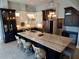 Modern kitchen with a large island, marble countertops, stainless steel appliances, and pendant lighting at 8025 Island Dr, Port Richey, FL 34668