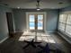 Light-filled living room featuring French doors to the pool and starfish-themed rug at 8025 Island Dr, Port Richey, FL 34668