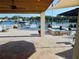 Back patio overlooking the water features a covered seating area, Jacuzzi, and tiled patio at 8025 Island Dr, Port Richey, FL 34668