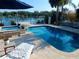 Sparkling pool and hot tub are surrounded by a tiled patio with waterfront views at 8025 Island Dr, Port Richey, FL 34668