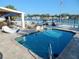 Backyard swimming pool and spa are surrounded by a patio overlooking the water at 8025 Island Dr, Port Richey, FL 34668