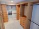 Spacious walk-in closet with custom wood shelving, drawers, and rod storage for optimal organization at 8025 Island Dr, Port Richey, FL 34668
