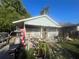 Charming single story home with a covered front porch and home gym at 8203 N Semmes St, Tampa, FL 33604