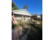 Home's front yard with a porch and a pathway at 8203 N Semmes St, Tampa, FL 33604