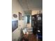 Hallway with neutral walls, wood flooring, and wall decorations at 8203 N Semmes St, Tampa, FL 33604
