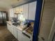 View of the kitchen with white cabinets, countertops, and tile flooring at 8203 N Semmes St, Tampa, FL 33604